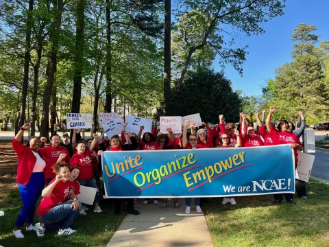 Wake NCAE members posing with a sign that says "United, Organize, Empower"